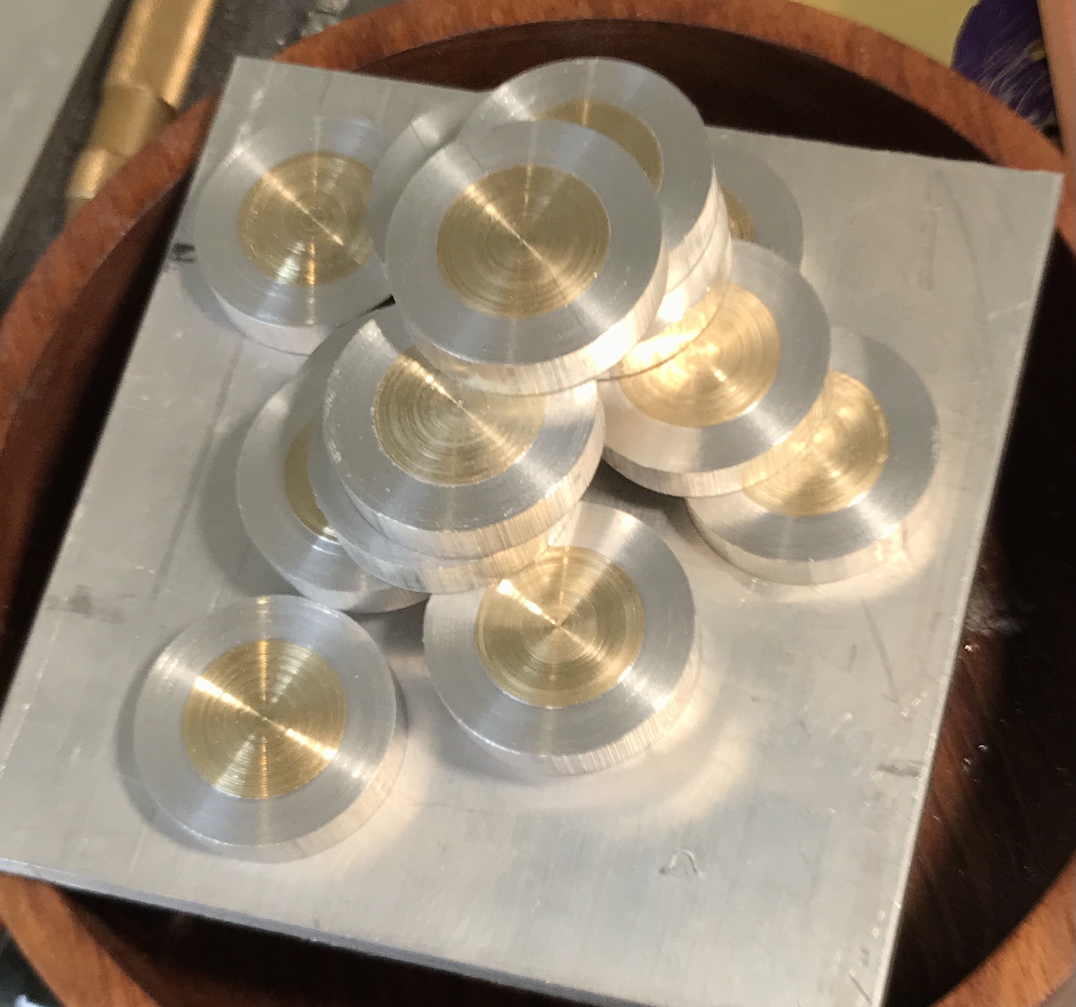 Fifteen brass and aluminum playing pieces.